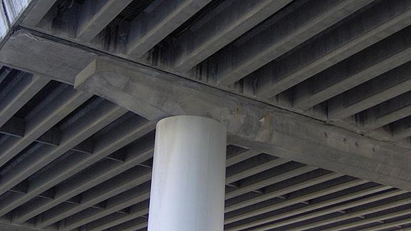 Titel der Produktbroschüre MicroFe - Brückenbau. Zu sehen ist ein Brückenpfeiler einer Stahlbetonbrücke.